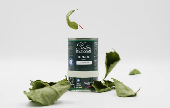 A packshot of Rubio Monocoat's Oil Plus 2C is surrounded by falling leaves