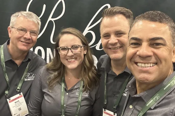 Quote Natalie Group photo at a fair of three men and one woman