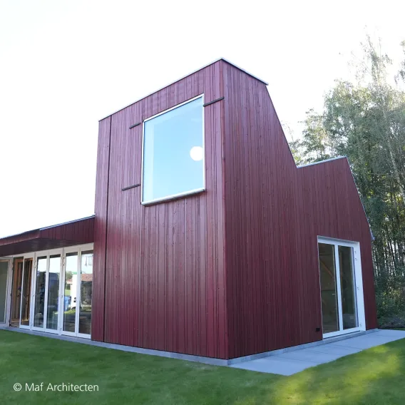 A building with red wooden cladding
