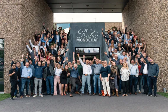 Group photo of about 100 employees