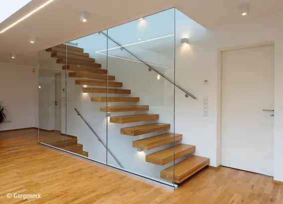Floating staircase with wooden floor and glass panel