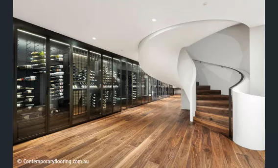 An impressive wine cellar with wooden floor and stairs