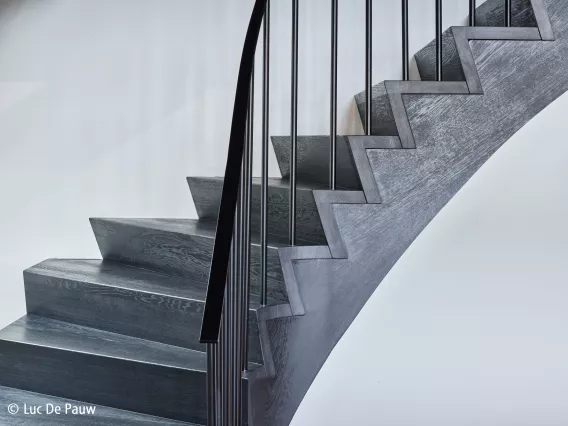 Detail shot of a black staircase with aluminum balluster